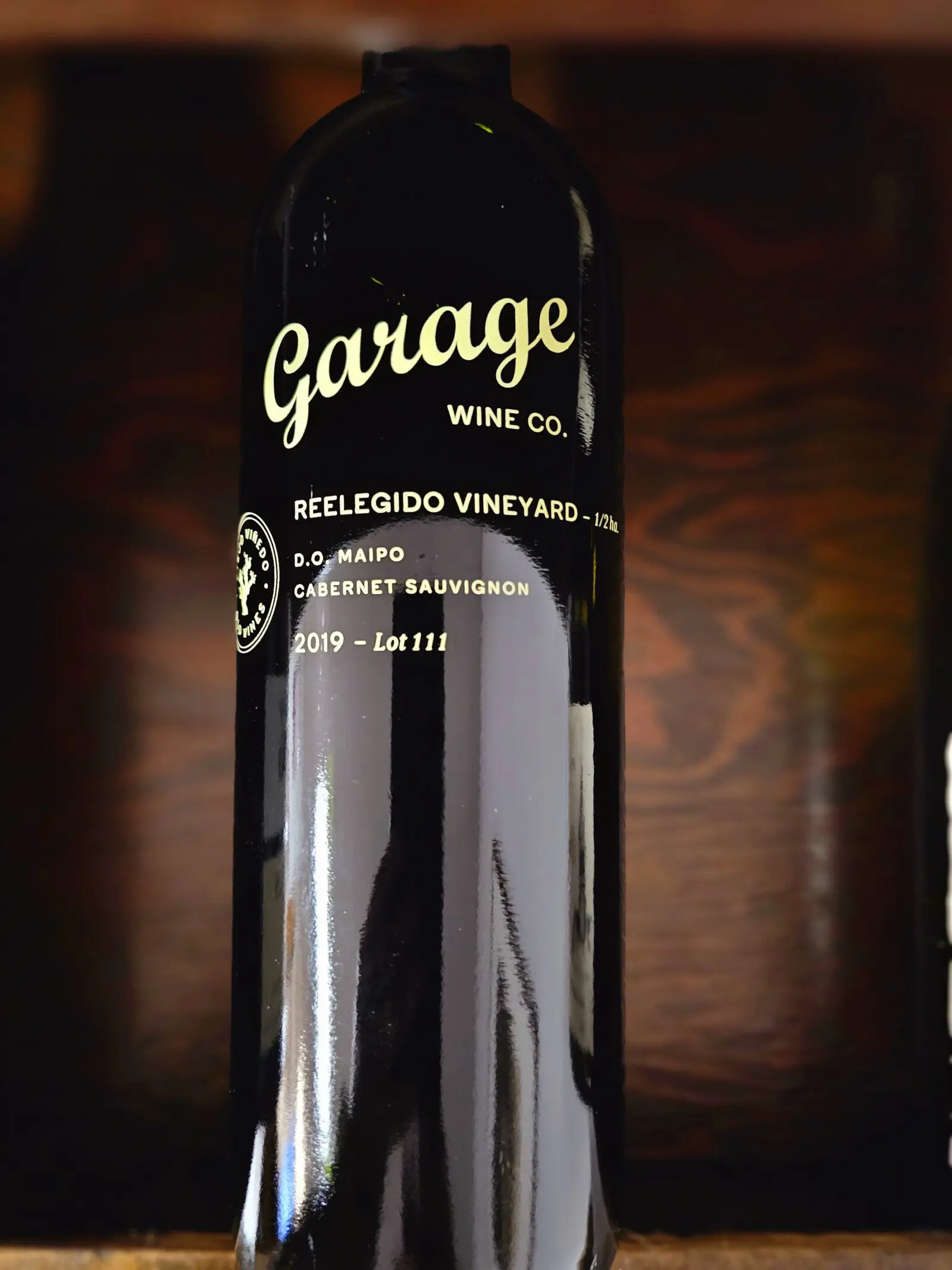 A bottle of wine against a dark background.