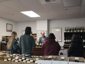 A wine tasting occurring at a counter.
