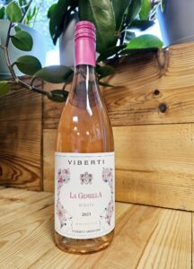 A bottle of Viberti Giovanni 2023 ‘La Gemella’ Rosata resting against a wooden background.