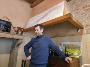 A man stands inside a room at Domaine Bart.