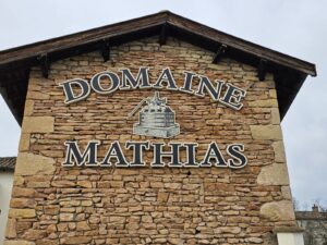 A sign displaying the name Domaine Mathias.