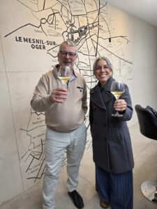 Two people holding wine glasses and smiling.