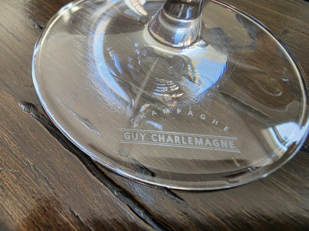 The base of a wine glass with a winery logo on it.
