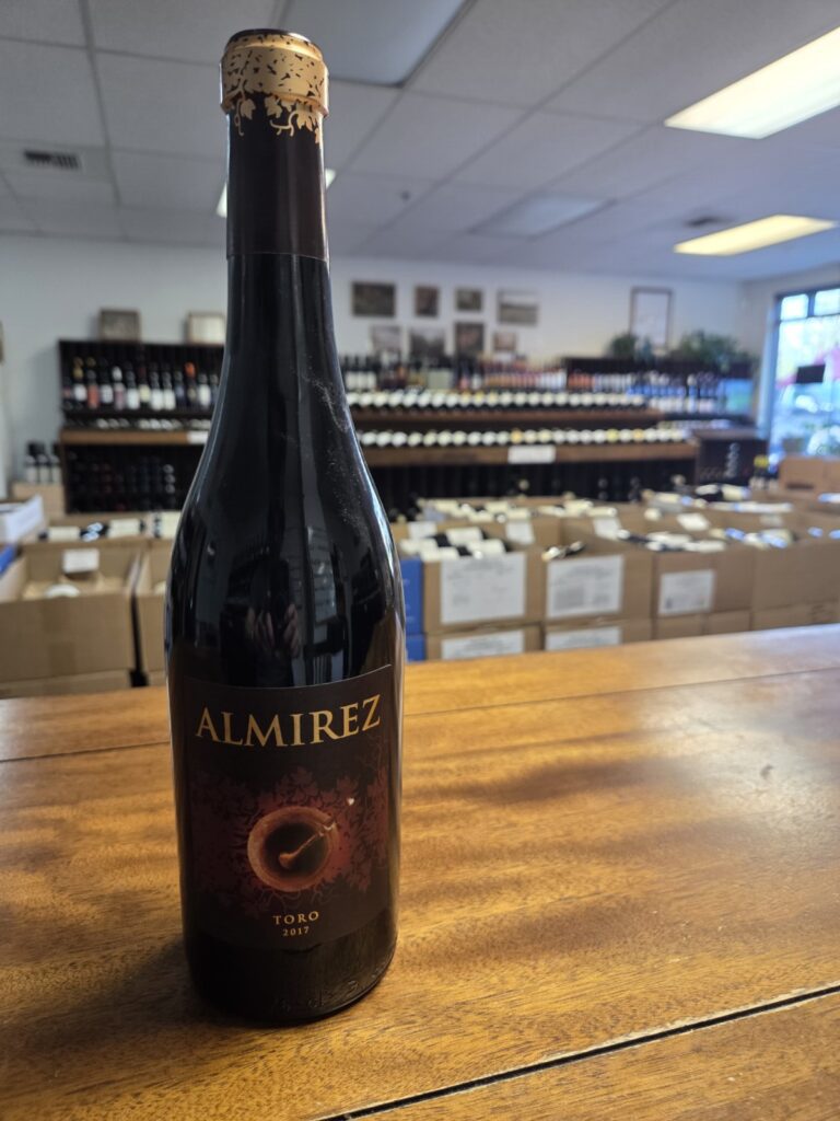 A wine bottle on a counter inside University Wines.