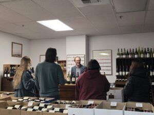 A wine tasting occurring at a counter.