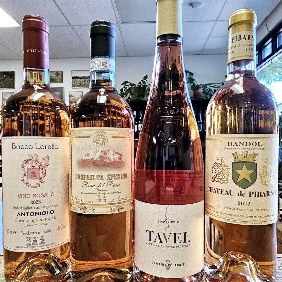 Four French and Italian rosé wine bottles positioned side by side.